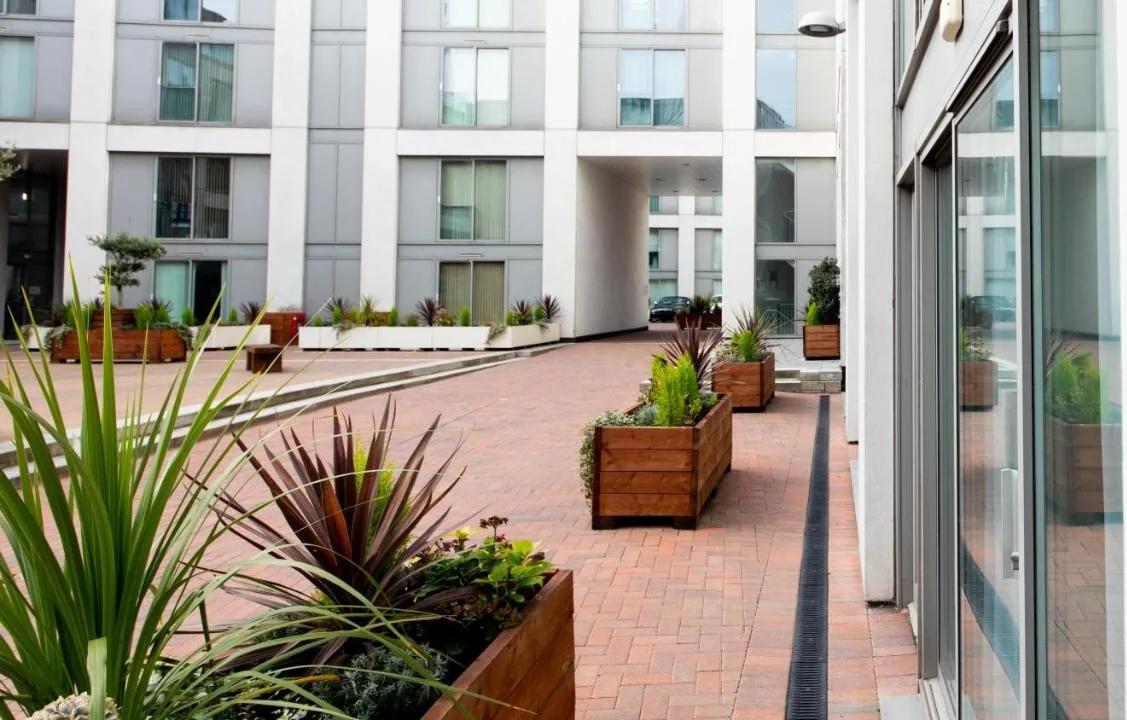 a courtyard with potted plants in a building at The Spires Serviced Apartments Birmingham in Birmingham